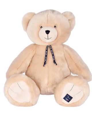Offrez l'exceptionnel Ours Maïlou Champagne de 65 cm. Une peluche géante de luxe faite main en Bretagne. Qualité artisanale EPV, douceur XXL et certificat d'authenticité.