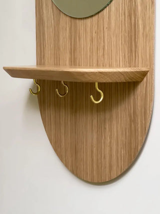 Craquez pour le miroir mural Éclipse de Reine Mère. Étagère en chêne, crochets noir/or et miroir écoresponsable. Un condensé de design breton chez CQFD Avignon.